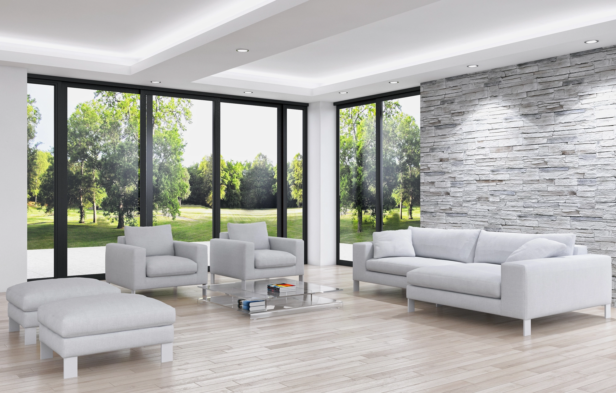 Wohnzimmer mit Sofasesseln vor großen Fenstern